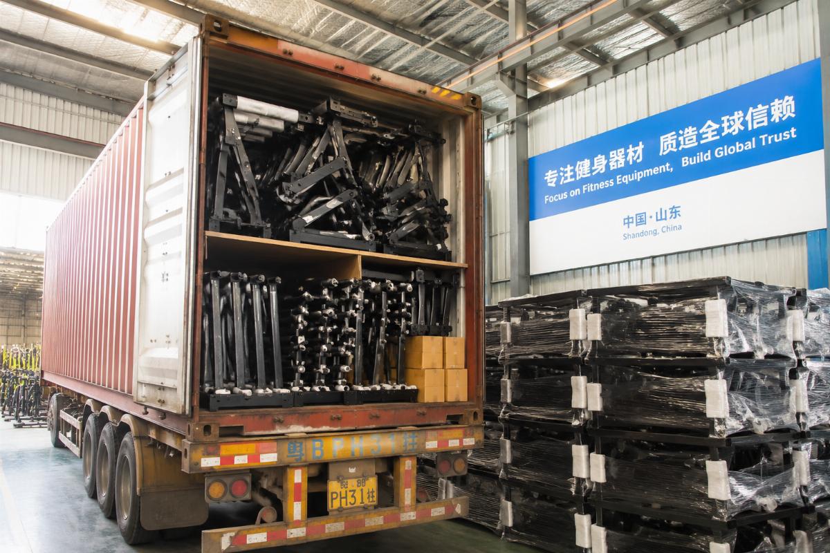 Stacked gym equipment ready for shipping in a 40HQ container at a Chinese factory warehouse