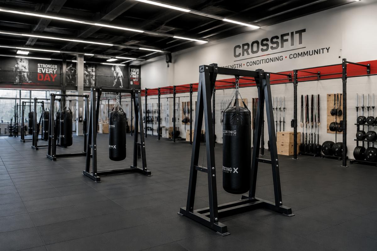 Free-standing commercial boxing bag racks arranged in a 120 sqm CrossFit training zone