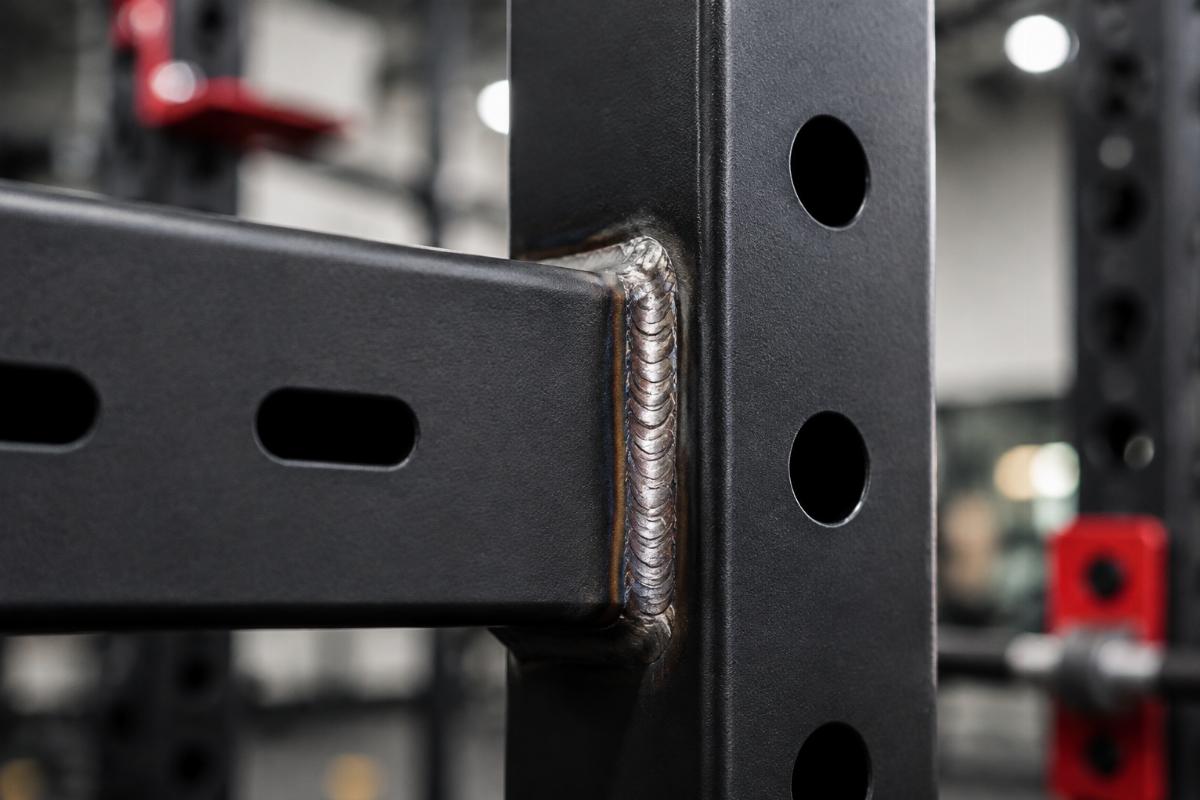 Close-up inspection of weld joint on functional training rig upright