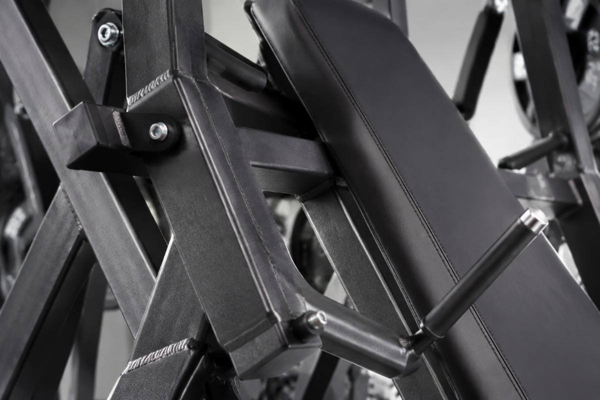 Close-up of commercial-grade incline chest press frame welds and high-density padding details