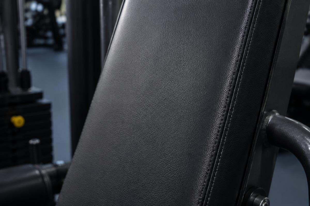 Close-up of commercial gym machine upholstery showing humidity-resistant material texture