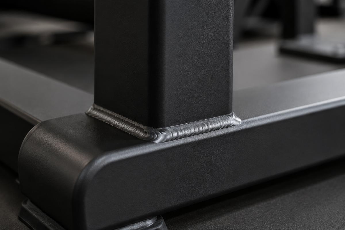 Close-up of full-penetration weld joint on a commercial Roman Chair frame showing smooth and continuous weld bead