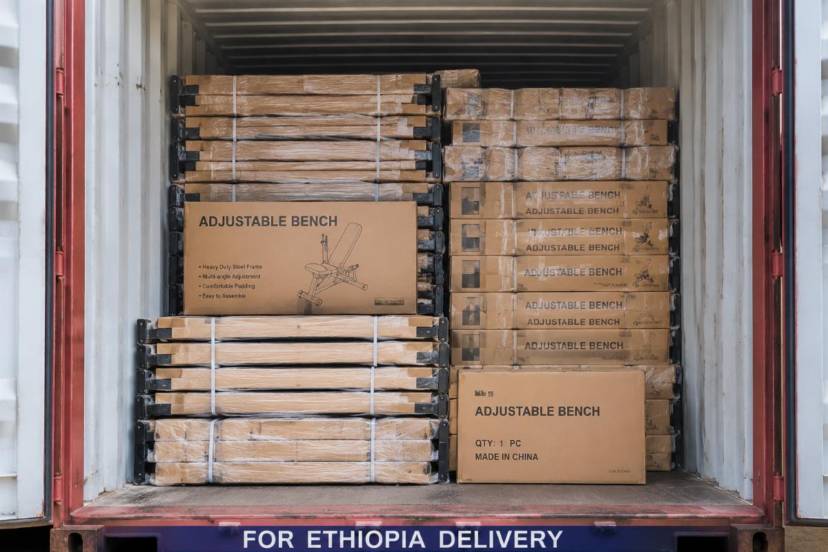 Flat-packed adjustable benches loaded efficiently in a shipping container for Ethiopia delivery