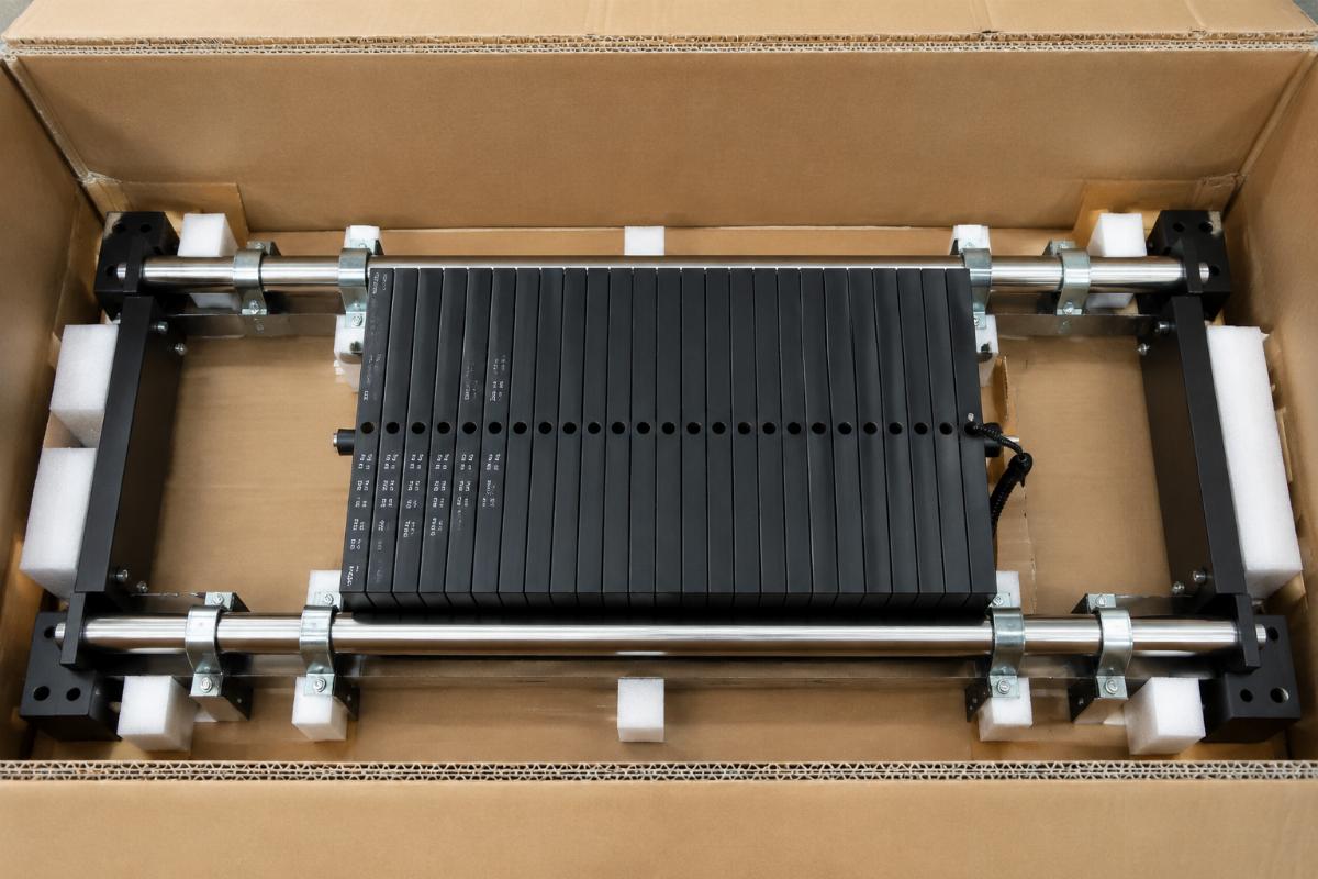 Pec Deck weight stack guide rail braced with multiple steel fixation clips inside an export carton
